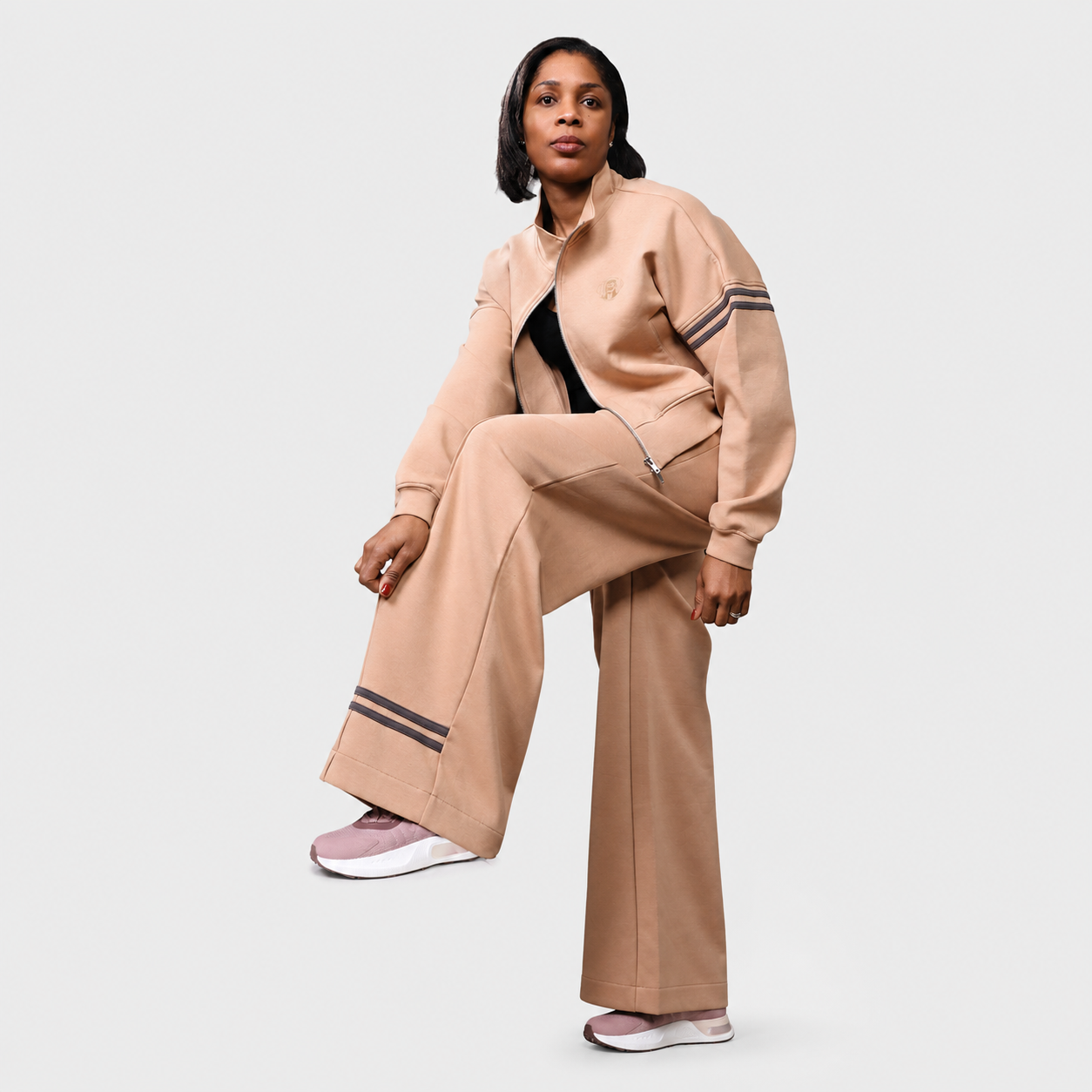 Elegant women's sand beige set with cropped zip jacket and wide-leg pants in modern streetwear style