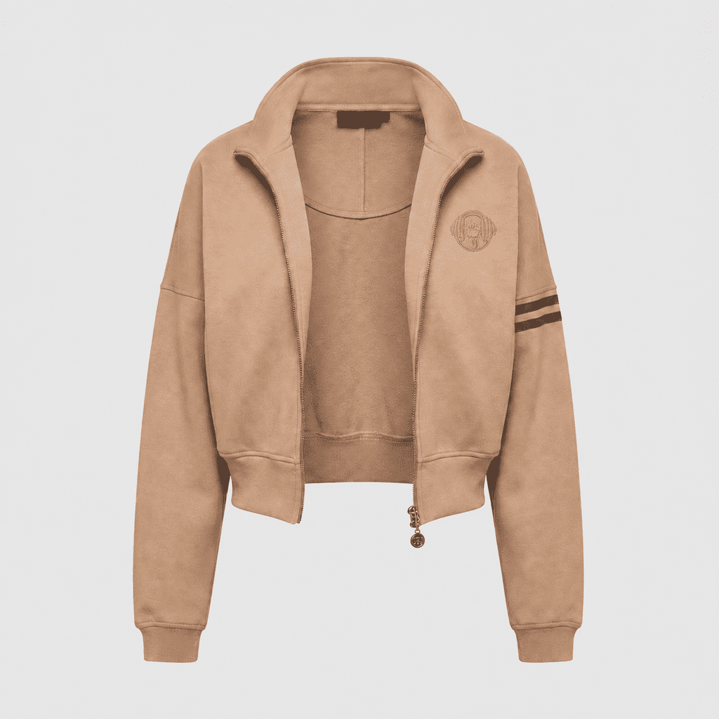 Close-up of sand beige cropped zip jacket with contrast stripe sleeve and embroidered logo