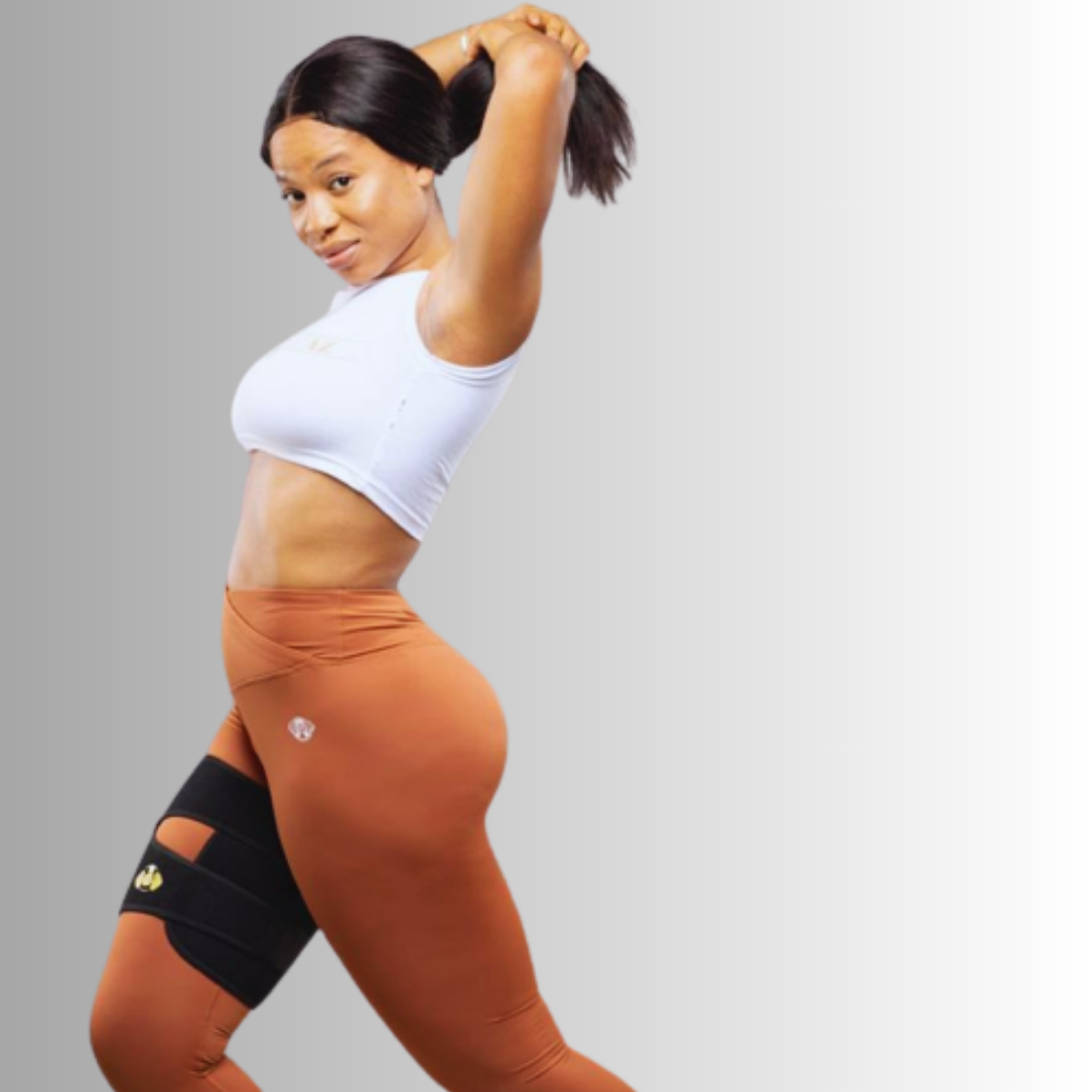 Elyo black thigh resistance band worn over leggings, side view
