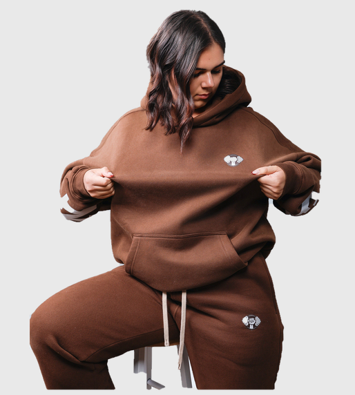 Front view of women's oversized brown hoodie and jogger set showing fleece texture and embroidered logo