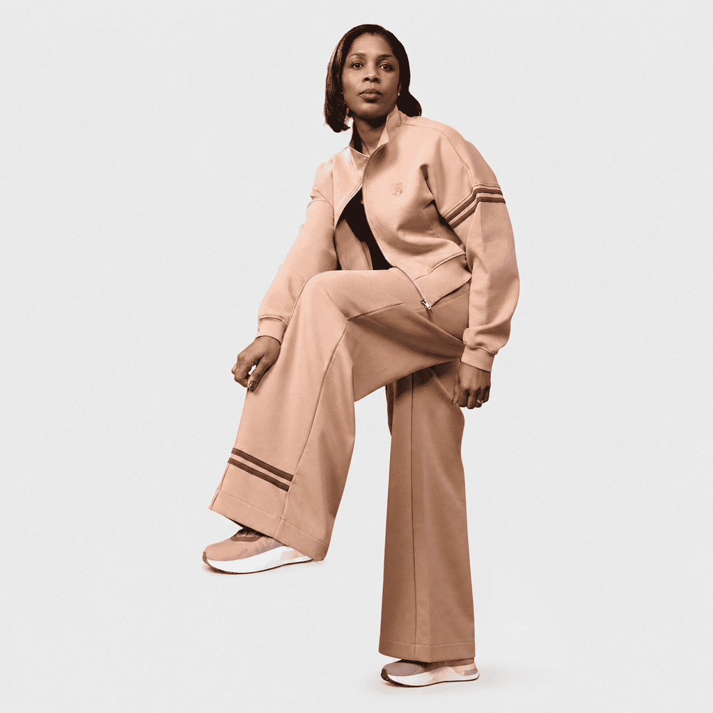 Woman modeling sand beige cropped tracksuit jacket and wide-leg sweatpants set