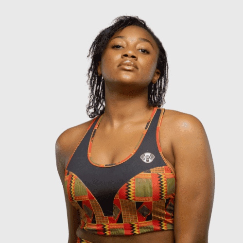 Woman wearing black high support sports bra with African cultural print panel
